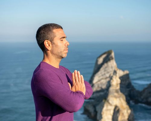 Man focused during meditation and breathing exercises outdoors.